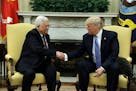 President Donald Trump shakes hands with with Palestinian leader Mahmoud Abbas during their meeting in the Oval Office of the White House, Wednesday, 