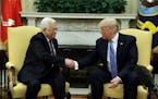 President Donald Trump shakes hands with with Palestinian leader Mahmoud Abbas during their meeting in the Oval Office of the White House, Wednesday, 