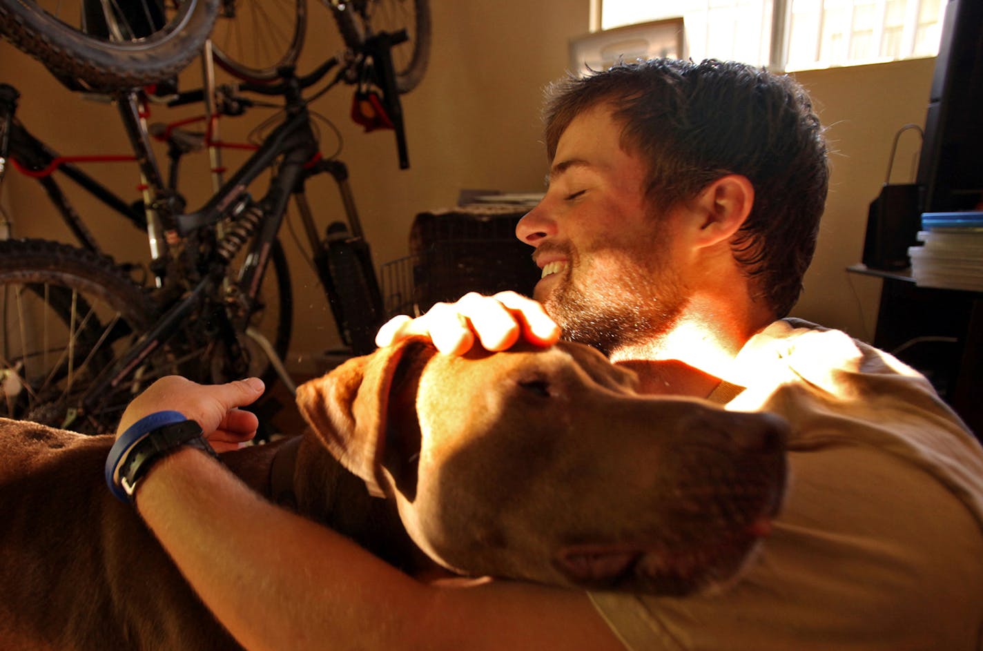 Clay Hunt, a Marine who was wounded in Iraq in 2007 and deployed a second time to Afghanistan in 2008, plays with "Max," adopted from the Mother of Hunt's fellow Marine and Iraq bunk-mate Blake H. Howey, who was killed in Iraq in 2007. Hunt faces bureaucratic nightmares when submitting disability claims with the Veterans Administration. Caption update: Hunt committed suicide in 2011.(Al Seib/Los Angeles Times/MCT) ORG XMIT: 1089553