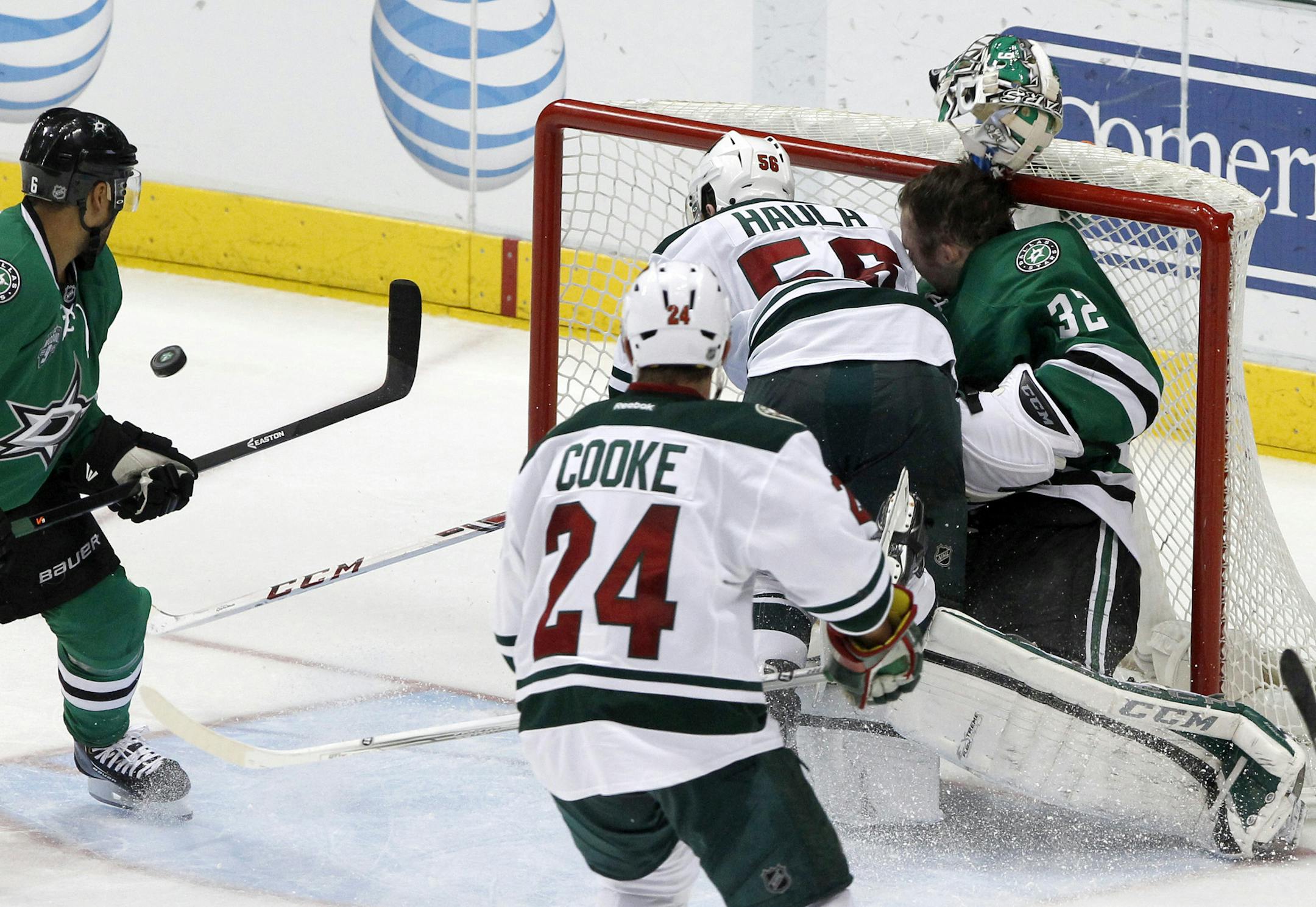 Minnesota Wild left wing Erik Haula (56) collides with Dallas Stars goalie Kari Lehtonen (32), who loses his helmet during the third period an NHL hockey game in Dallas Saturday, March 8, 2014. The Stars won 4-3. (AP Photo/Richard W. Rodriguez)