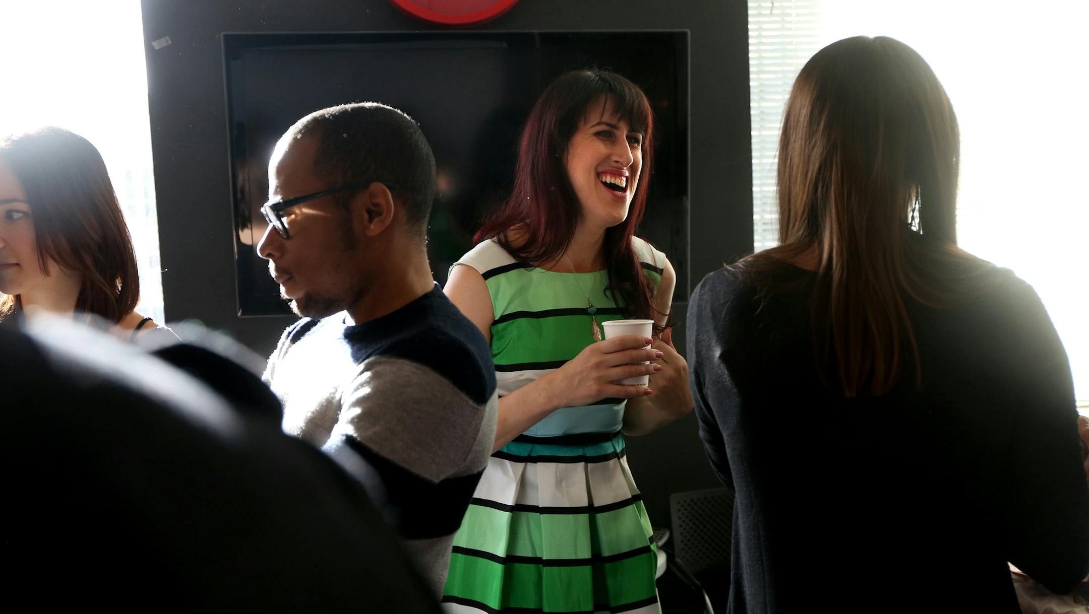 Chloe mingles with her co-workers at Leo Burnett in Chicago for the first time since returning to work from the holidays after her colleagues learned of her transition on Monday, Jan. 4, 2016. Her colleagues gave her a surprise party on her first day back. (Nancy Stone/Chicago Tribune/TNS) ORG XMIT: 1179296