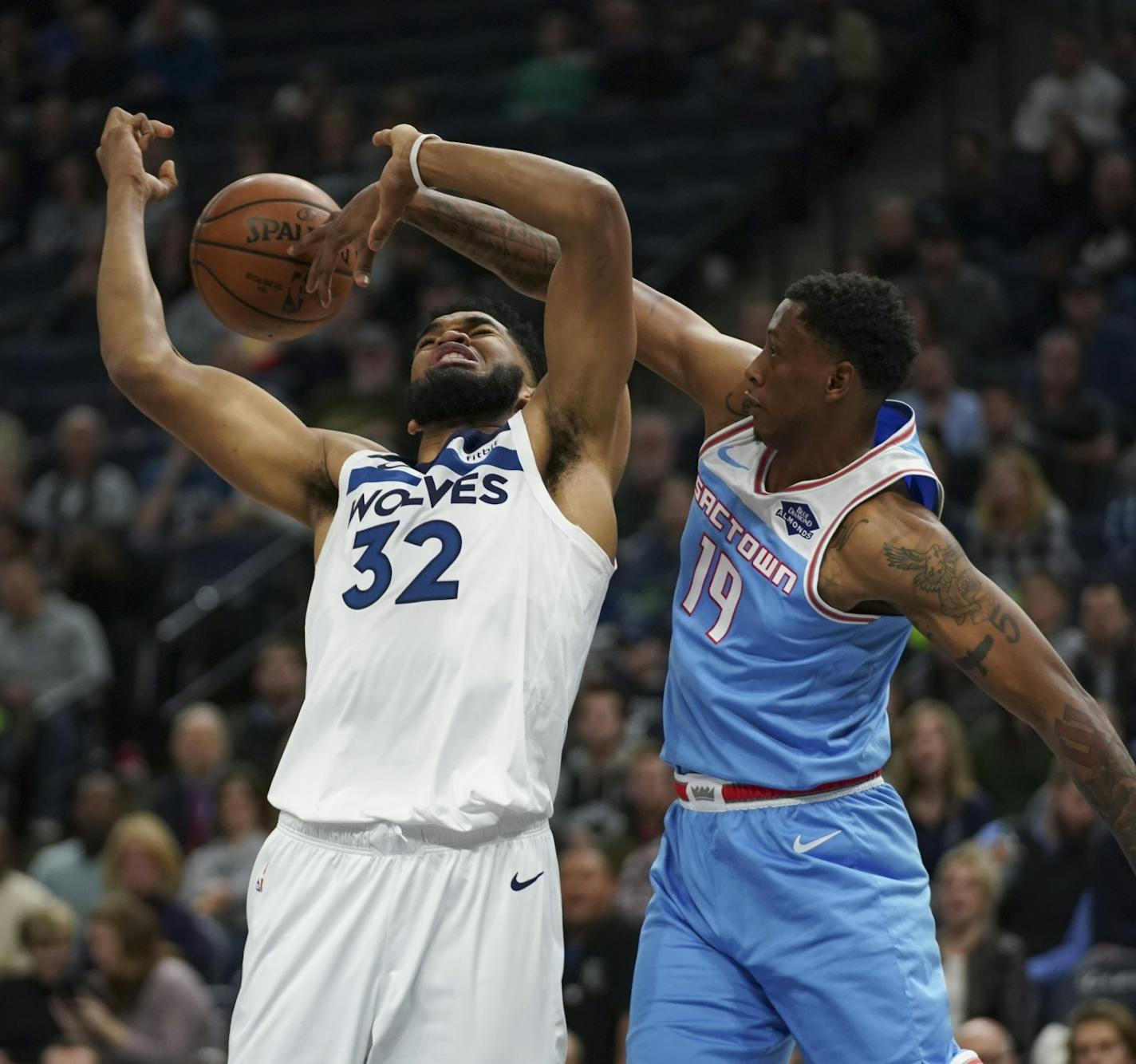 Sacramento Kings forward Troy Williams (19) slapped the ball away from Minnesota Timberwolves center Karl-Anthony Towns (32) in the second quarter.