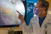 Dr. Scott Cutover, a gastroenterologist at MNGI, points to a green square on a screen where a GI Genius module is detecting a polyp needing further ob