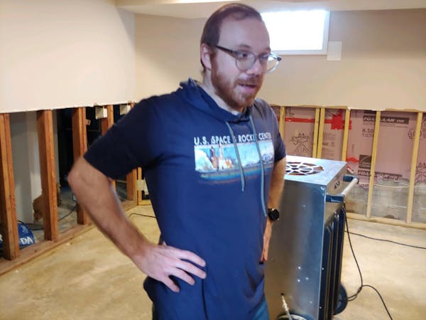 Dimi Lalos stood in front of a large humidifier, trying to air out his basement after a water main break flooded his house Friday. The sheetrock behin