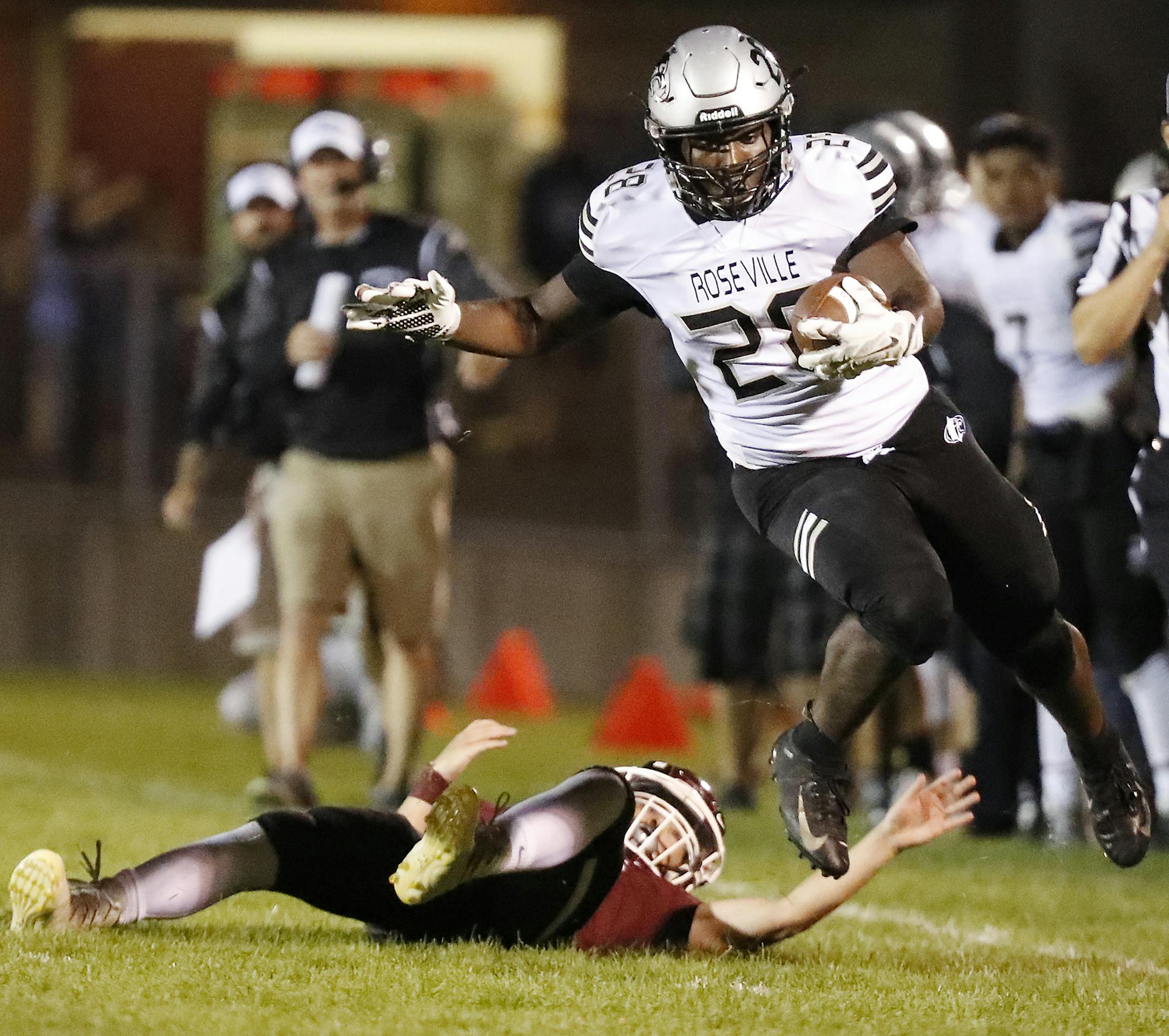 Roseville Area High School running back Cameron Rease (28) runs with the ball, escaping the tackle of Anoka High School's Mitch Anderson during the second half. ] LEILA NAVIDI ï leila.navidi@startribune.com BACKGROUND INFORMATION: Roseville Area High School plays against Anoka High School in the opening football game of the season in Anoka on Thursday, August 30, 2018. Roseville Area High School won the game 22-7.