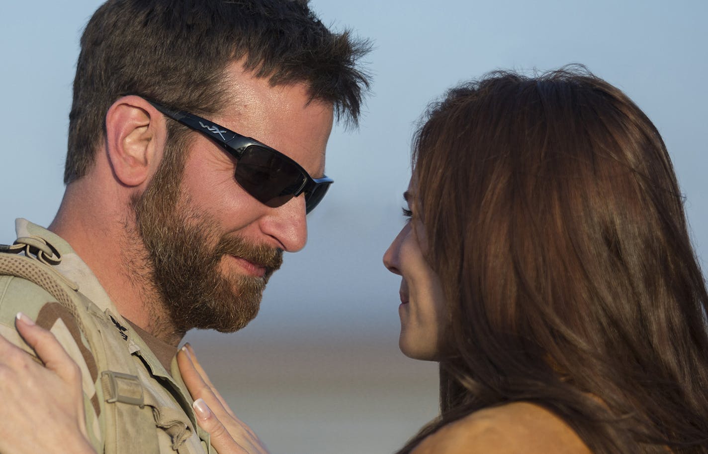 Bradley Cooper as Chris Kyle and Sienna Miller as Taya in Warner Bros. Pictures' and Village Roadshow Pictures' drama "American Sniper."