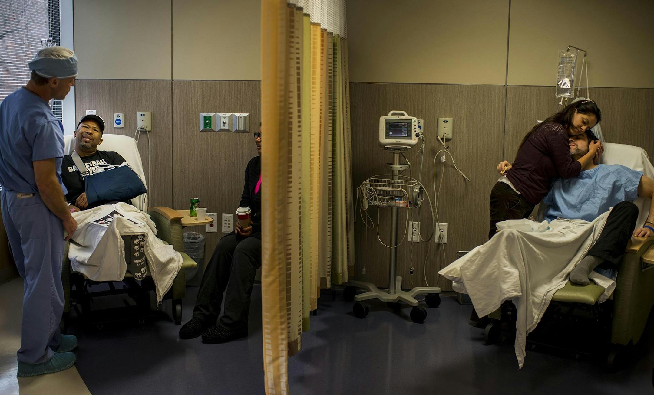 At the Massachusetts Avenue Surgery Center in Bethesda, Md., physician James Gilbert speaks with Mark Edwards; in an adjoining space, James Patton is hugged by his wife, Andrea. Illustrates SURGERY-CENTERS (category l), by Sandra G. Boodman, special to The Washington Post. Moved Monday, December 15, 2014. (MUST CREDIT: Washington Post photo by Melina Mara.)