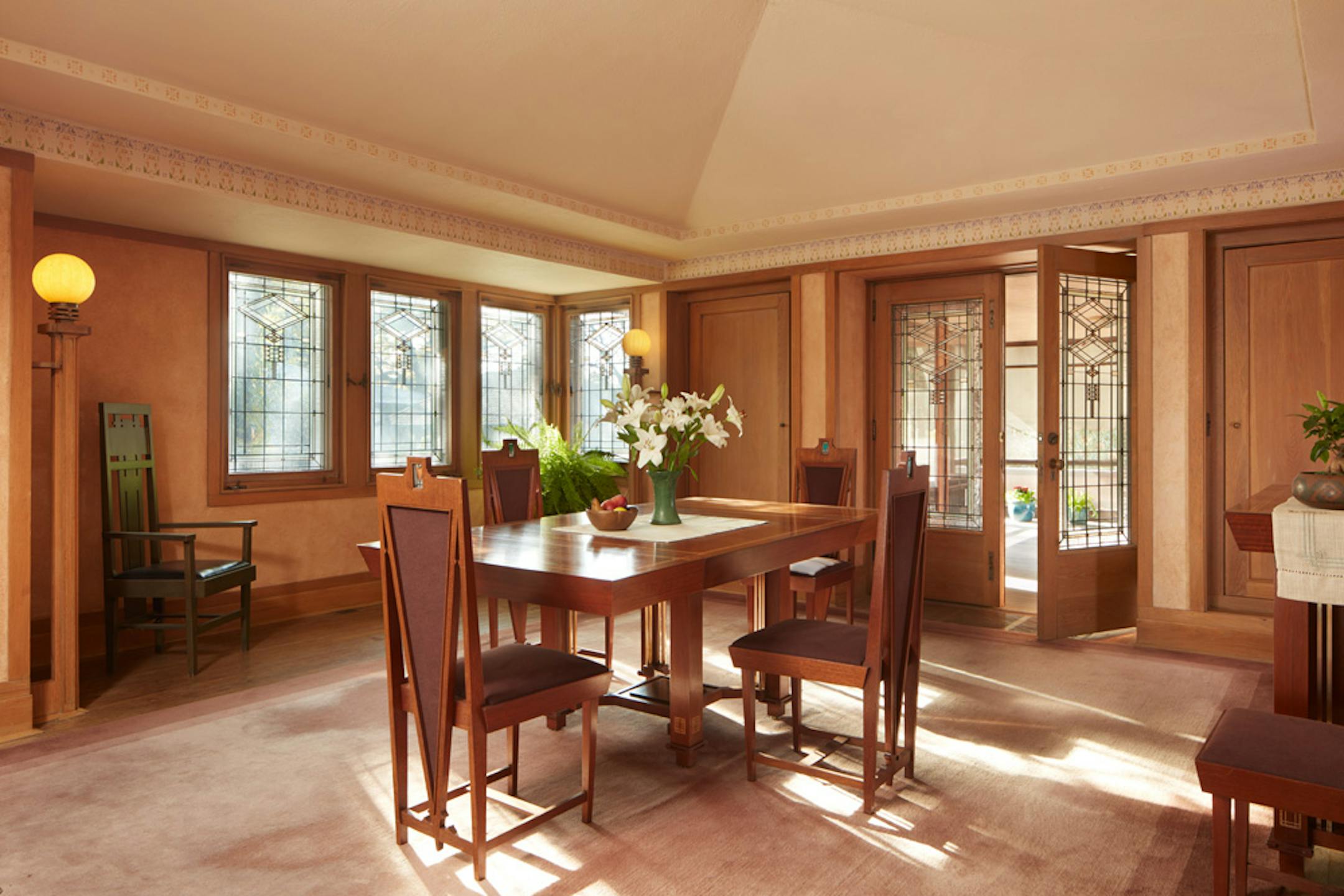 Purcell-Cutts House, 2328 Lake Place, Minneapolis, Minnesota, 1913, William Gray Purcell, Architect.George Elmslie, George Feick Jr. partners in firm Purcell, Feick and Elmslie, Edna S. Purcell House, Prarie School Style, Open floor plan, Art Glass windows, Writing Nook, Fireplace wall Mural by Charles Livingston Bull, Louisana Herons Flying with two Moons, Iridescent glass mortered in frieplace base, Stencil pattern, Peak a Book stained glass entry, Grandfather Gray portrait by Lawton Parker in Entrance Hall, Dining room Art Glass double door to screend-in Porch, Reflecting Pool and landscape designed by Harry Franklin Baker, Living room, Stair Hall, Master Suite, Sleeping Porch, Built in cedar floor storage, fireplace, childrens room connected to master with accordian style operating partition, sunken Living room,tent Ceilings, Ceiling Lights and art glass by Mosaic Art Shops Minneapolis, Maid Call Button, Air conditioning, Central vacuum system, sliding kitchen door operated by foot button, icebox in kitchen with door to outside, custom Sitting chair, Custom Floor lamp, Custom Dining room table,chairs and sideboard, Custom Cluster Pendant lighting, Oak hardwood floors and trim, Custom Throw rugs, Continuous tented roof and ceiling, Elevated dining room, dropped floor living room, "Little Joker", Personalized home with monogram ESP for Edna S. Purcell,