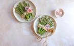 Two plates with asparagus and radishes, served with a zesty Lemon-Herb Tahini Sauce and radishes on the side.