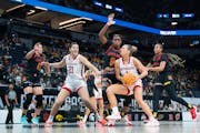 Nebraska guard Jaz Shelley (1) drives in on Maryland guard Shyanne Sellers (0) during the first quarter of Saturday's Big Ten tournament semifinals. S