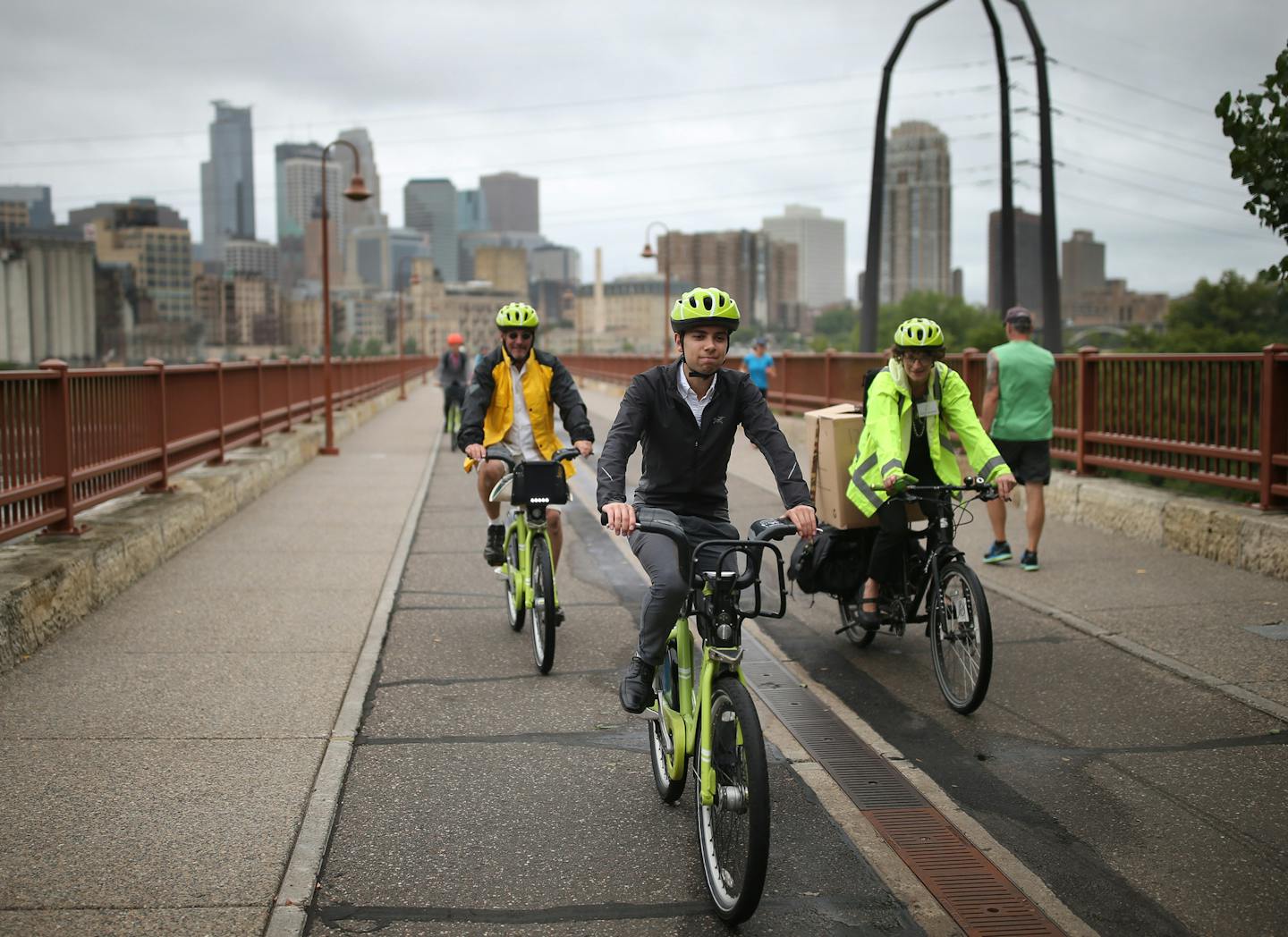 Evan Gruenes biked across the Stone Arch Bridge during an art tour. City of Minneapolis and Minneapolis Park and Recreation Board launch six interactive map tours that make it easy to explore public art in the city Thursday August 17, 2017 in Minneapolis, MN. ] JERRY HOLT &#xef; jerry.holt@startribune.com