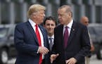 FILE - In this Wednesday, July 11, 2018, file photo, President Donald Trump, left, talks with Turkey's President Recep Tayyip Erdogan, as they arrive 