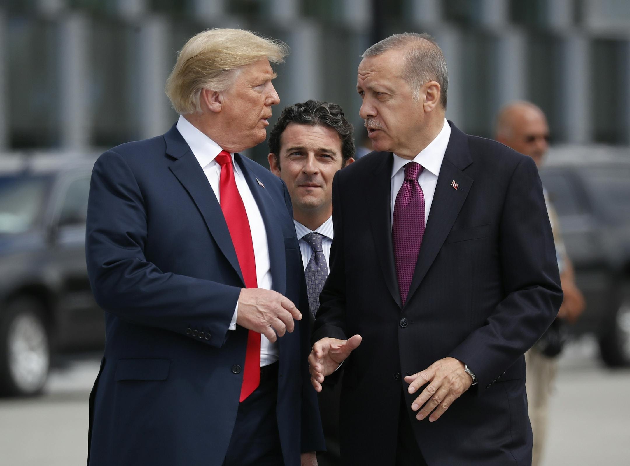 FILE - In this Wednesday, July 11, 2018, file photo, President Donald Trump, left, talks with Turkey's President Recep Tayyip Erdogan, as they arrive together for a family photo at a summit of heads of state and government at NATO headquarters in Brussels. The White House says Turkey will soon invade Northern Syria, casting uncertainty on the fate of the Kurdish fighters allied with the U.S. against in a campaign against the Islamic State group.