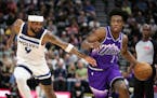 Jazz guard Collin Sexton (2) dribbles around Wolves guard Nickeil Alexander-Walker during the first half Monday night in Salt Lake City, where the tea
