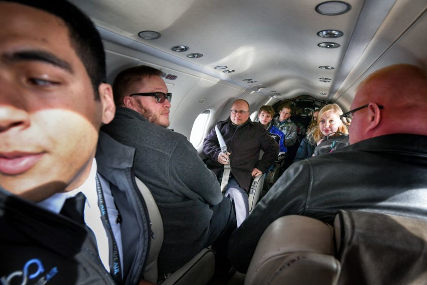 First officer Joshua Williams, left, had to squat down as he gave the preflight safety talk to the eight passengers heading to Thief River Falls.