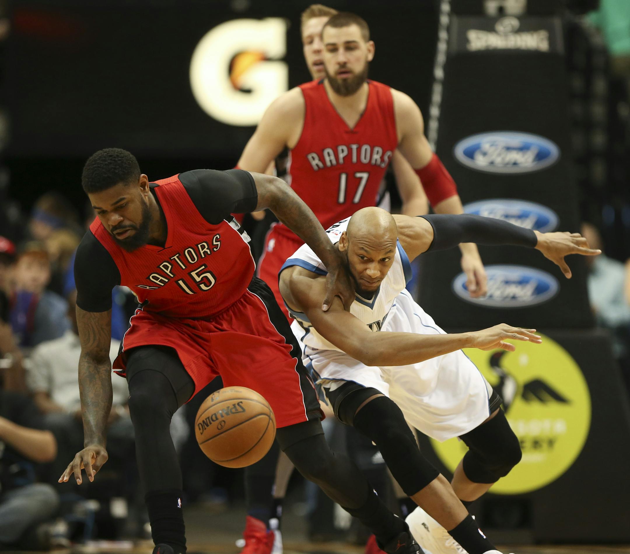 The Raptors' Amir Johnson (15) and the Timberwolves' Adreian Payne (3) fought for a loose ball in the first quarter Wednesday night at Target Center.
