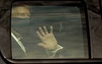 U.S. President Donald Trump waves to his supports from a motorcade outside Walter Reed Medical Center during his treatment for COVID-19 on Sunday, Oct