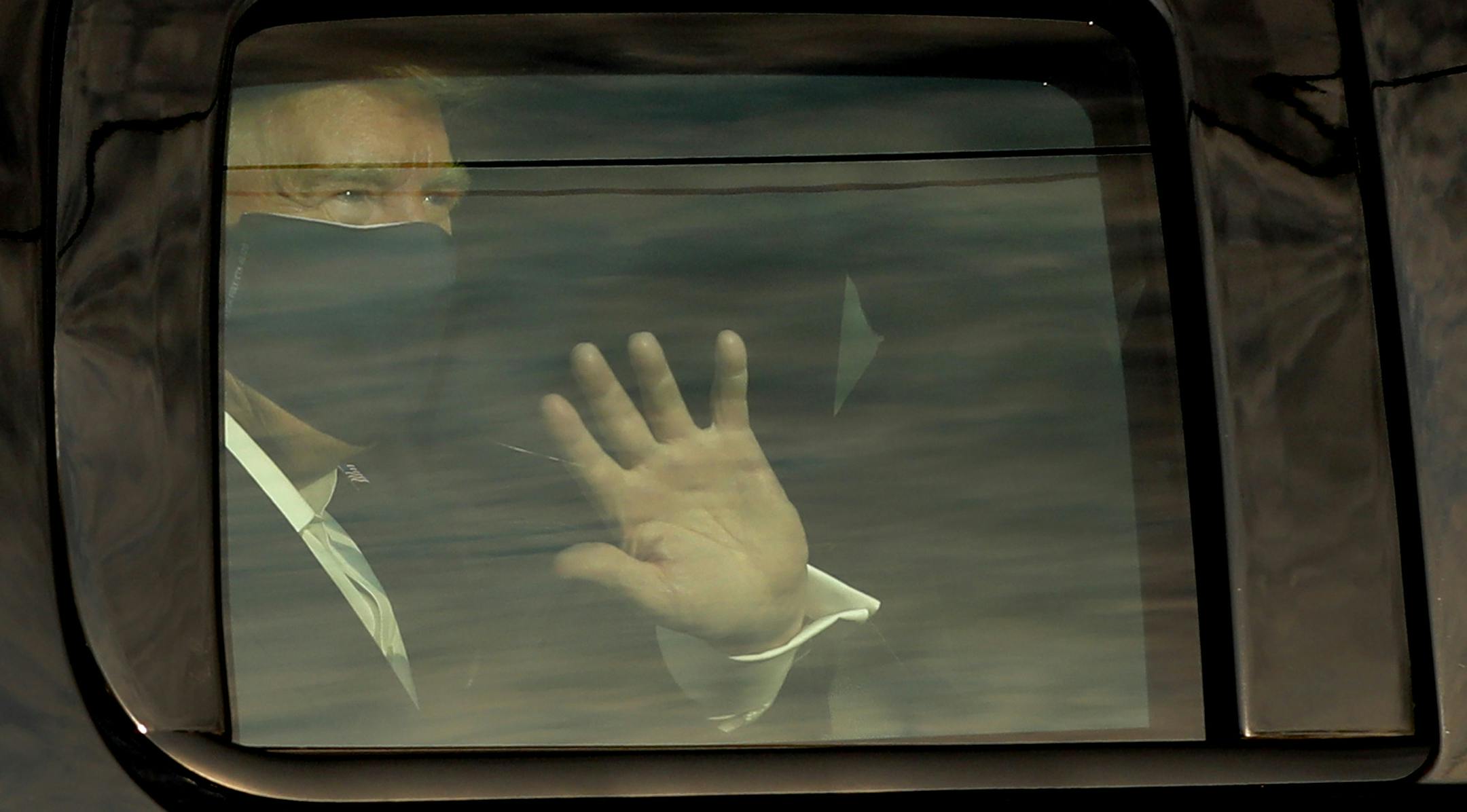 U.S. President Donald Trump waves to his supports from a motorcade outside Walter Reed Medical Center during his treatment for COVID-19 on Sunday, Oct. 4, 2020 in Bethesda, Maryland. (Yuri Gripas/Abaca Press/TNS) ORG XMIT: 1786909