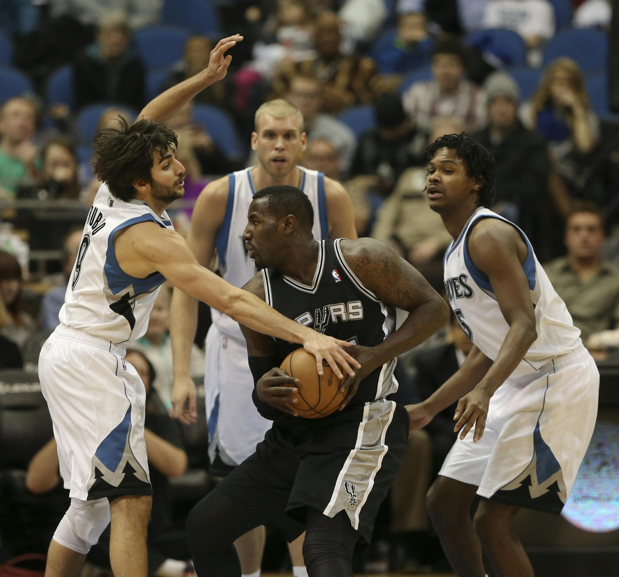 The Minnesota Timberwolves crushed the San Antonio Spurs 107-83 in an NBA basketball game Tuesday night, March 12, 2013 at Target Center in Minneapolis, Minn. The Wolves' Ricky Rubio drew a foul in the third quarter when knocking the ball from DeJuan Blair of San Antonio's hands. He was with teammates Greg Stiemsma and Mickael Gelabale, right.