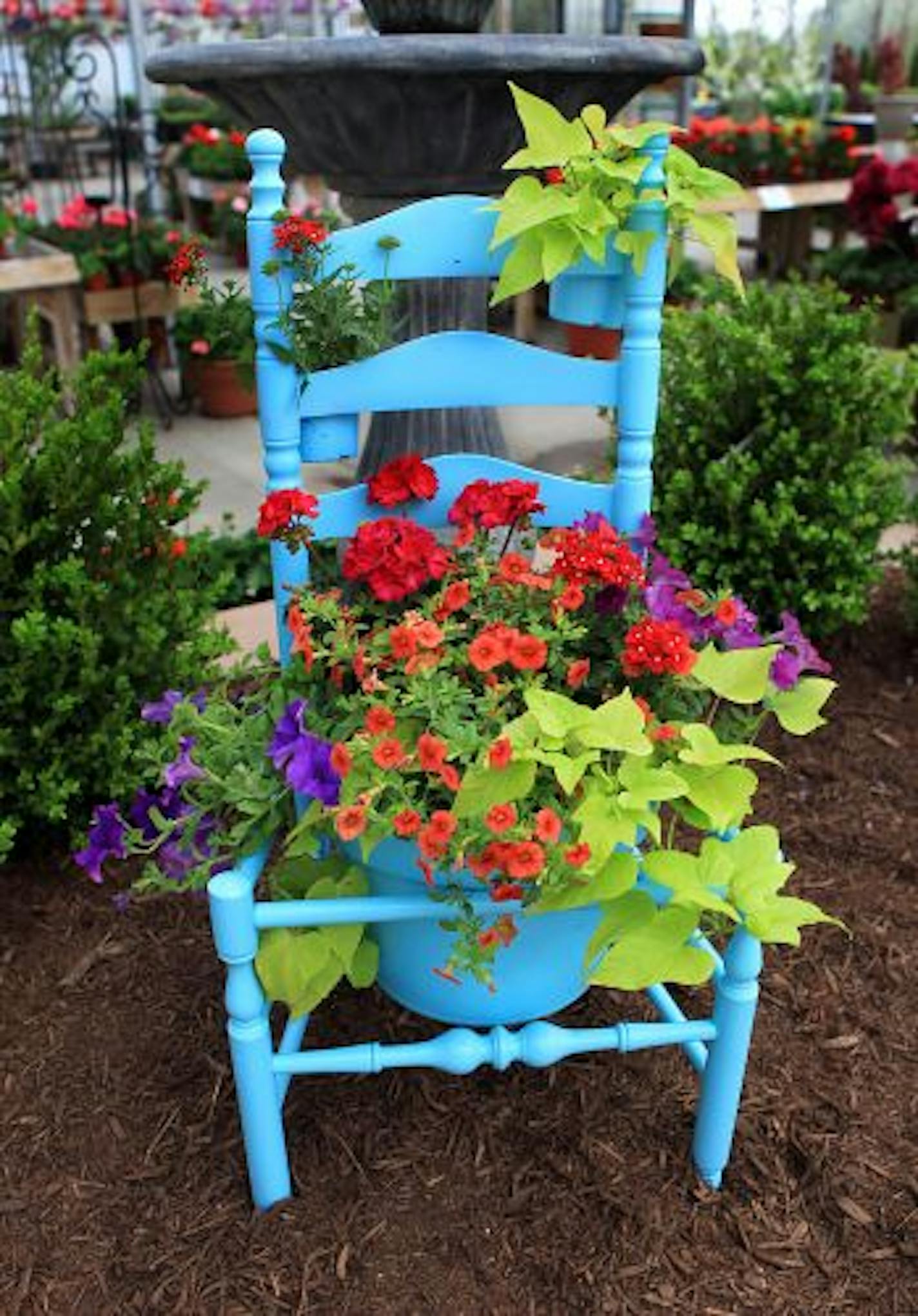 Bright paint and flowers revive a worn-out chair.