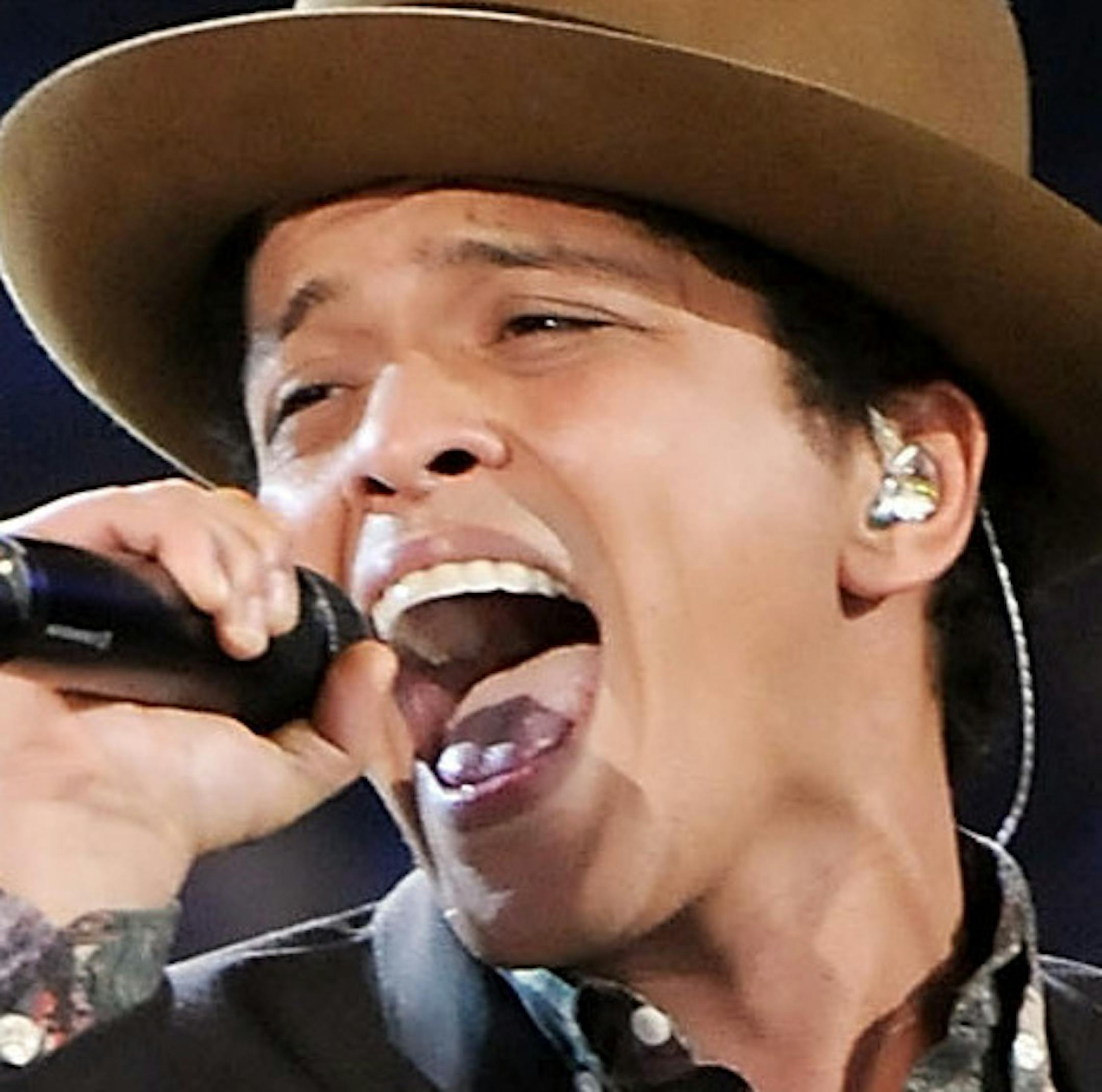 FILE - In this Nov. 7, 2012 file photo, Bruno Mars performs during the 2012 Victoria's Secret Fashion Show in New York. Las Vegas is set to ring in 2014 with big-name concerts, celebrity-hosted parties and an eight-minute rooftop fireworks display billed as the nation's largest. Mars is christening the Cosmopolitan's new Chelsea Ballroom. The show will be broadcast live on the casino's 65-foot (20-meter) marquee to ice skaters at a rooftop rink and partyers on the Strip below. (Photo by Evan Ago