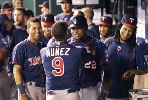 Minnesota Twins designated hitter Miguel Sano (22) is congratulated by teammate Eduardo Nunez (9) following his solo home run during the 12th inning.