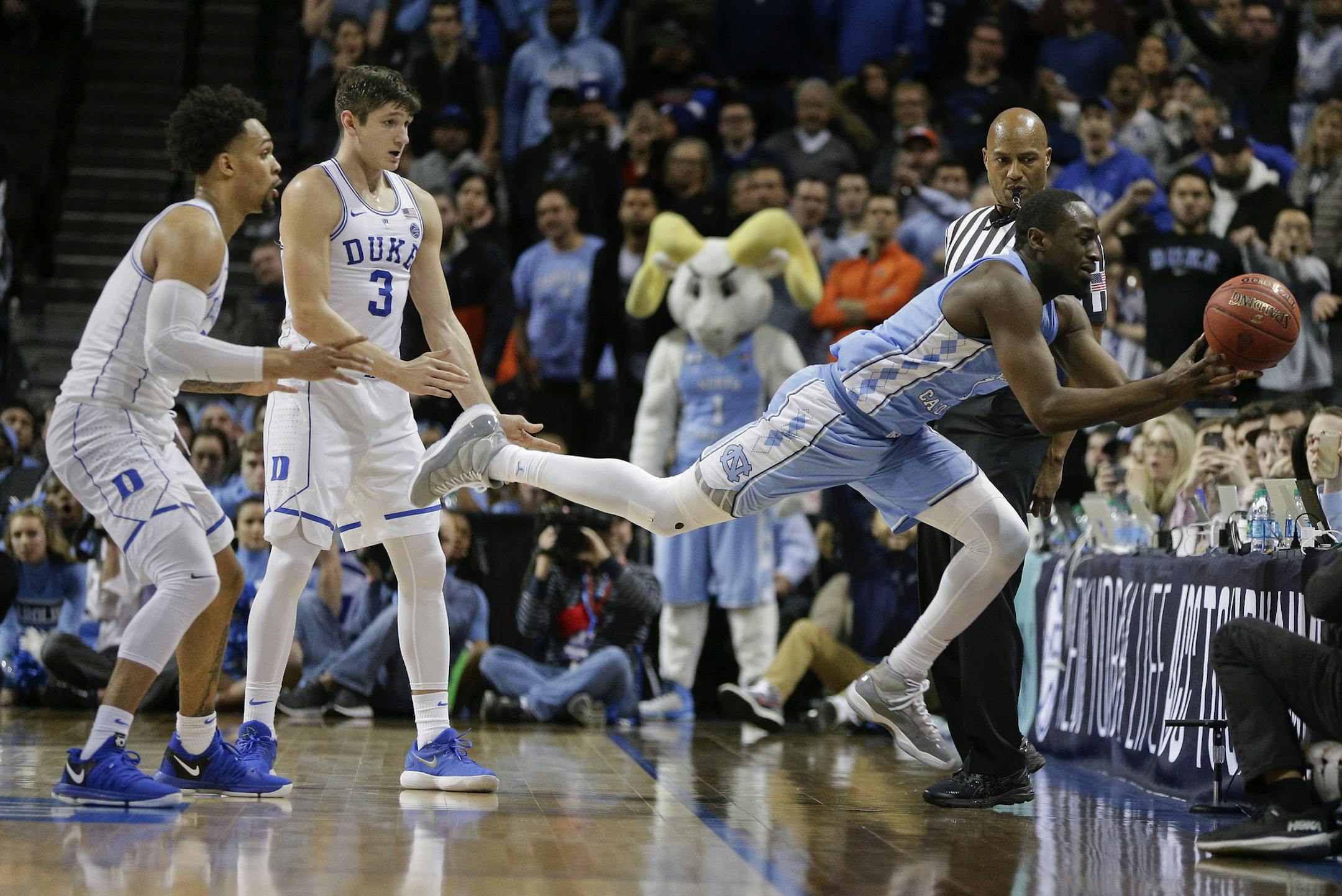 North Carolina forward Theo Pinson (1) loses control of the ball and tries to save it from going out of bounds as Duke guard Gary Trent Jr., left, and guard Grayson Allen (3) watch during the second half of an NCAA college basketball game in the Atlantic Coast Conference men's tournament semifinals Friday, March 9, 2018, in New York. North Carolina won 74-69. (AP Photo/Julie Jacobson)
