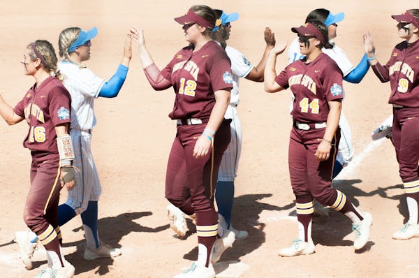 Minnesota Gophers and UCLA Bruins showing good sportsmanship after the game at the 2019 Women's College World Series at the Softball Hall of Fame in O