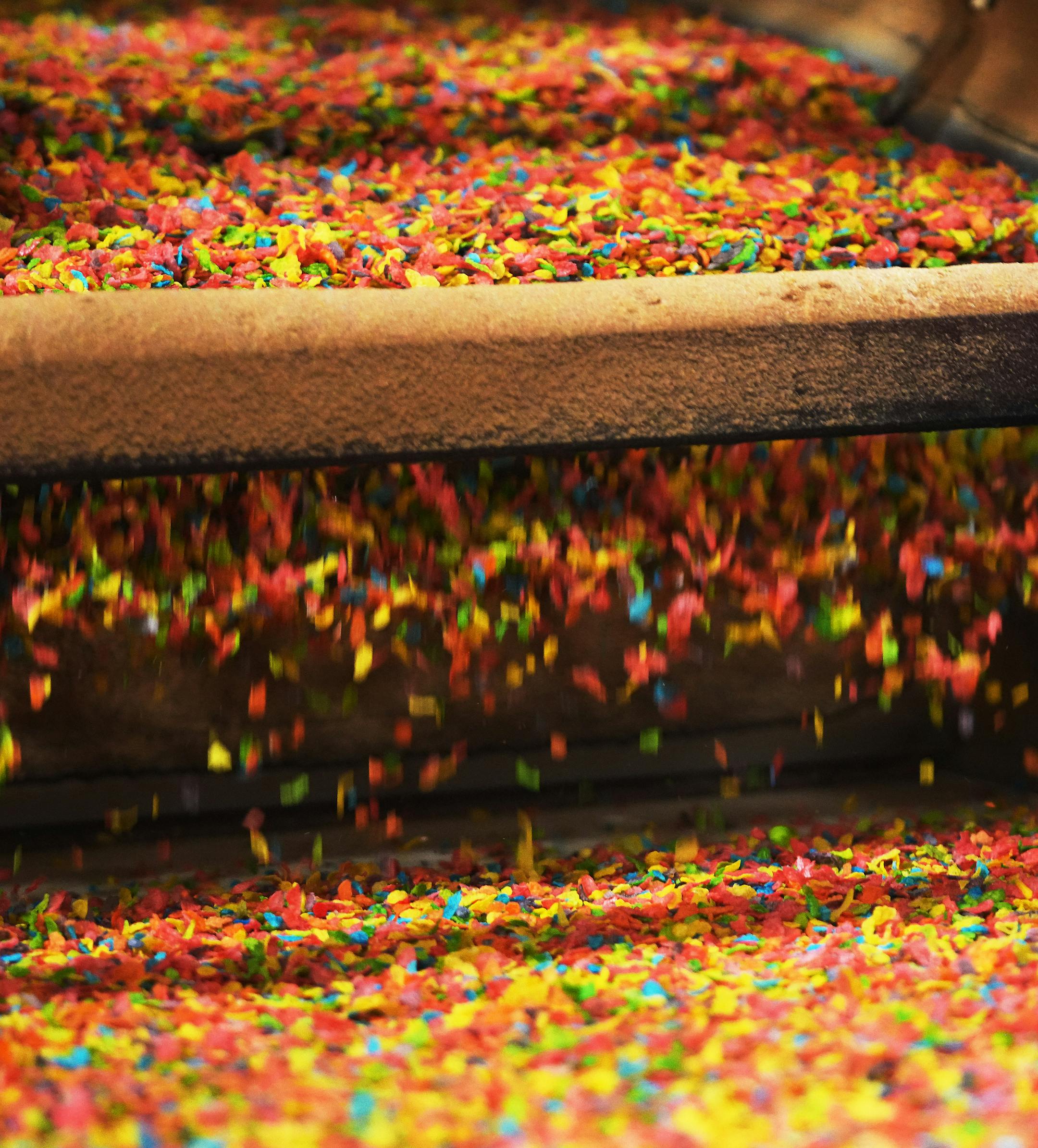 Rice is popped and emerges onto a conveyor to become Fruity Dyno Bites.