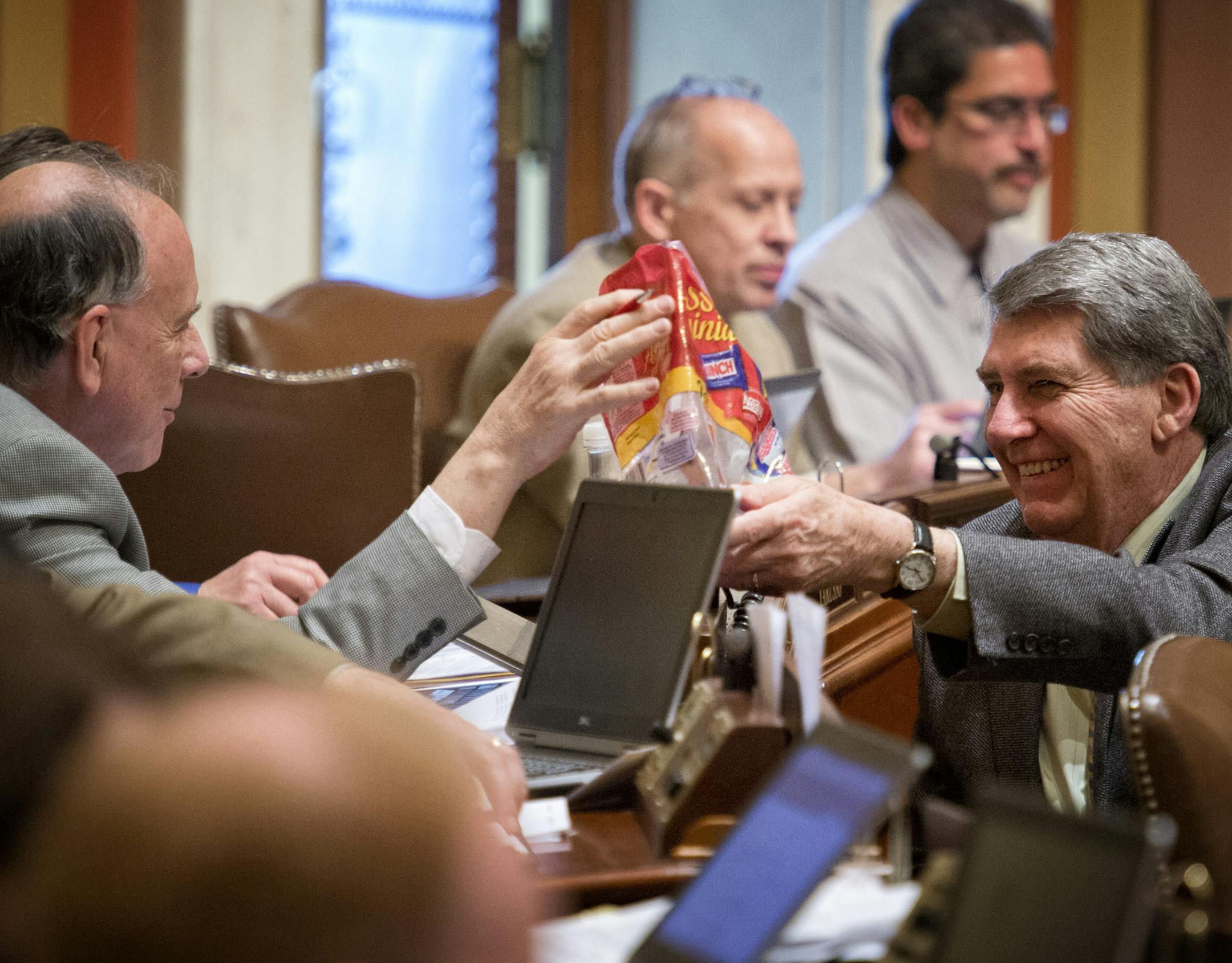 Rep. Jerry Newton, DFL-Coon Rapids, right passed a bag of tiny candy bars to Rep. Joe Mullery, DFL-Minneapolis during House debate of the tax bill. Wednesday, April 24, 2013 ] GLEN STUBBE * gstubbe@startribune.com