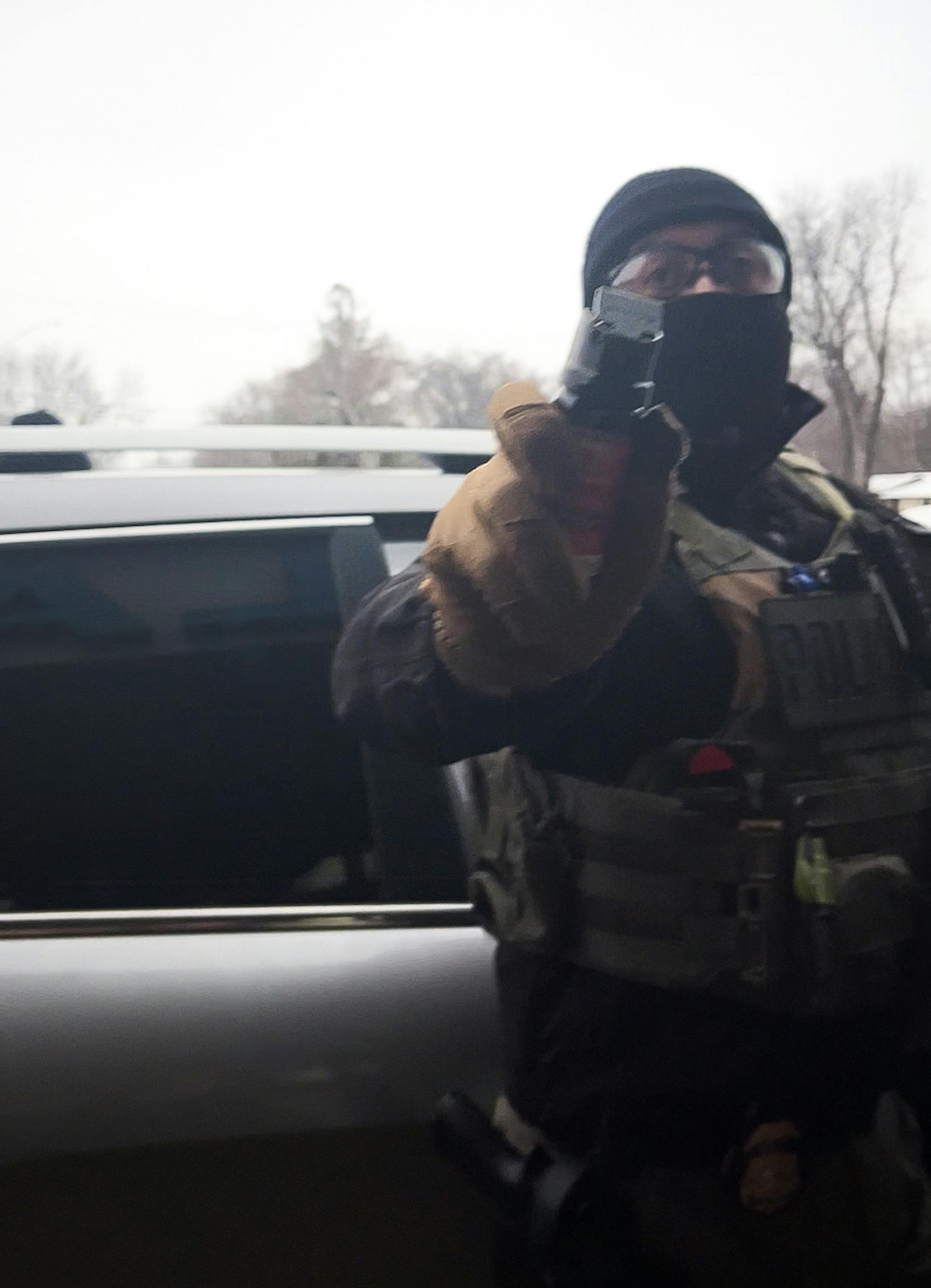 In this video still, an Immigration and Customs Enforcement agent points pepper spray at Magstadt's partner.