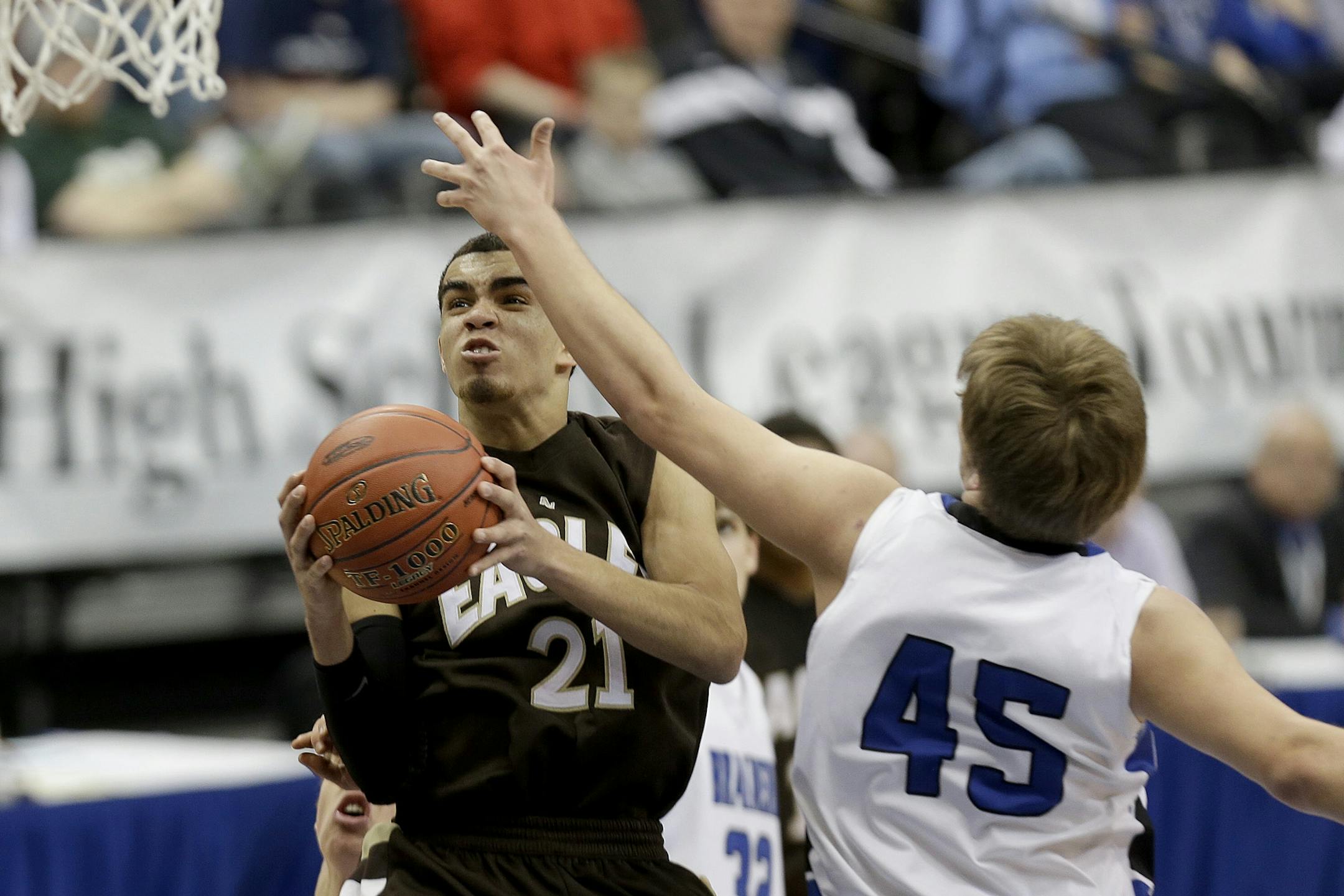 Tyus Jones went up for two under pressure by Brainerd's Jagar Hanson during the second half of the boys' basketball quarterfinals at the Target Center, Wednesday, March 20, 2013 in Minneapolis.