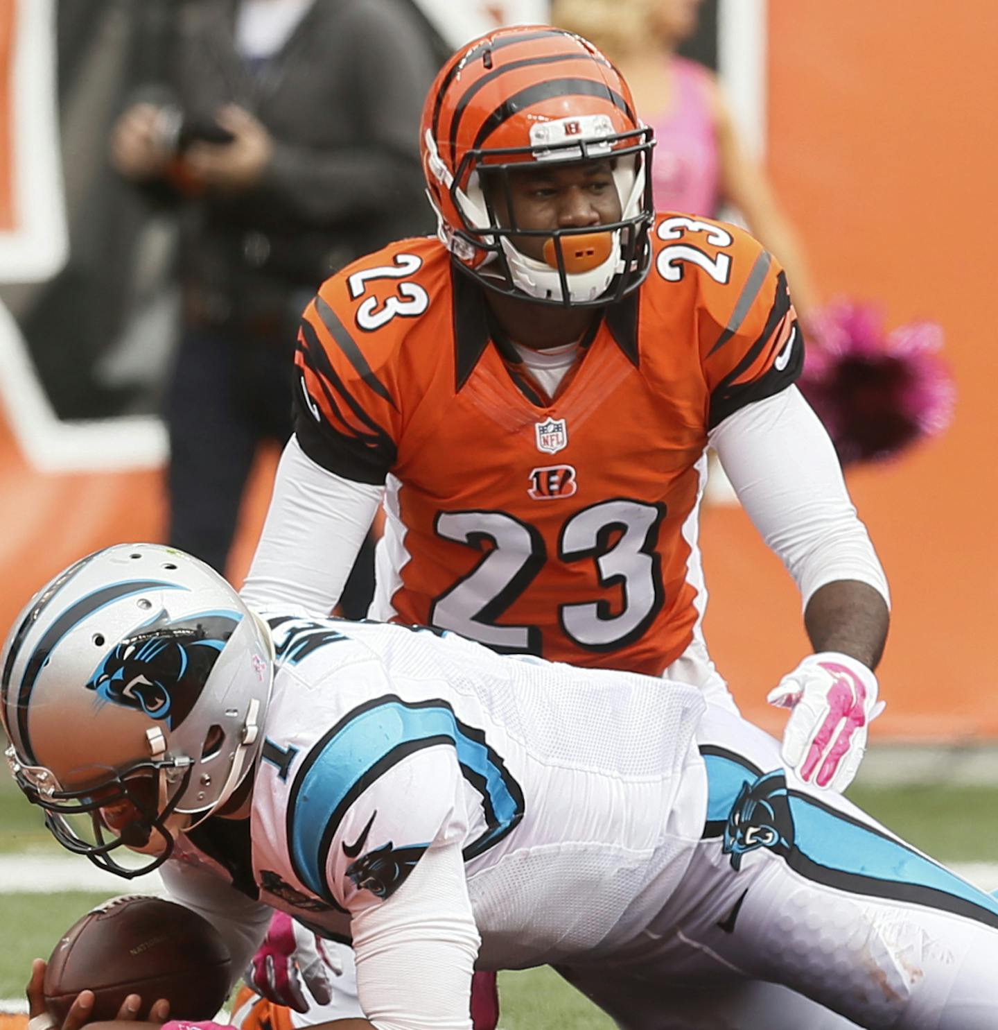 Carolina Panthers quarterback Cam Newton (1) runs through Cincinnati Bengals cornerback Terence Newman (23) and outside linebacker Vontaze Burfict (55) for a 12-yard touchdown in the second half of an NFL football game, Sunday, Oct. 12, 2014, in Cincinnati. (AP Photo/Paul Sancya) ORG XMIT: PBS101