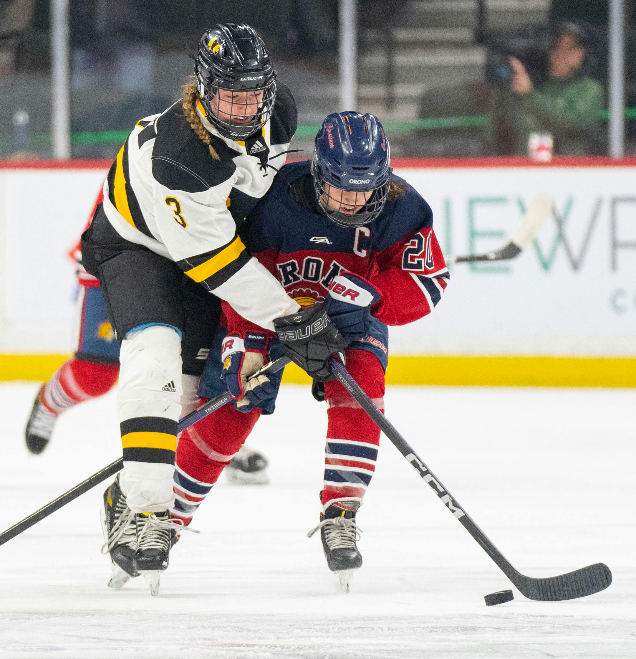 Warroad defenseman Lexi Kirkeby (3) and Orono defenseman Grace Bickett (20) fight for the puck in the first period.