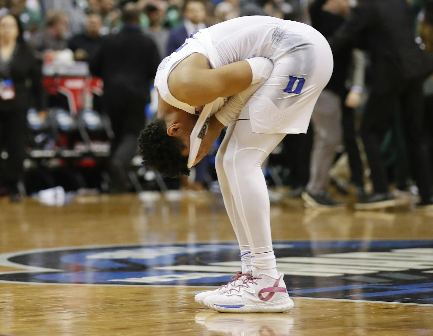 Duke guard Tre Jones covers his face after losing to Michigan State in the NCAA men's East Regional final college basketball game in Washington, Sunday, March 31, 2019. Michigan State won 68-67. (AP Photo/Alex Brandon)