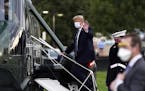 FILE - In this Oct. 5, 2020, file photo, President Donald Trump boards Marine One at Walter Reed National Military Medical Center after receiving trea