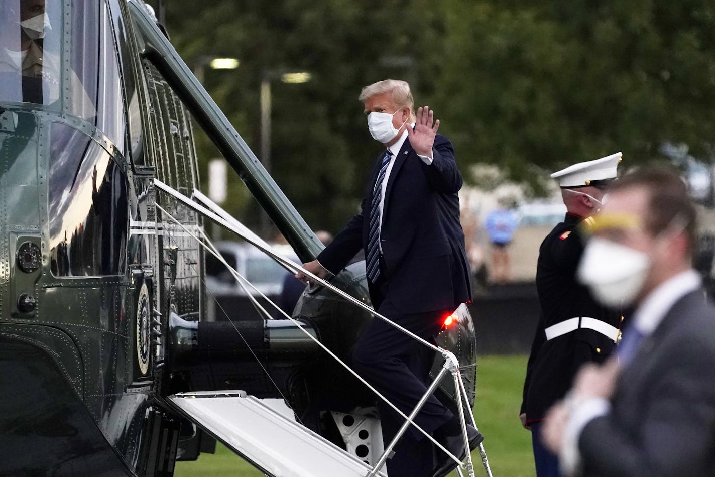 FILE - In this Oct. 5, 2020, file photo, President Donald Trump boards Marine One at Walter Reed National Military Medical Center after receiving treatment for coronavirus in Bethesda, Md. Ethics experts say the special treatment Trump received to access an experimental COVID-19 drug raises fairness issues and the public's right to know more about Trump's condition. (AP Photo/Evan Vucci, File)