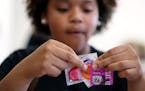 Yalanda Rivera 15, checks the expiration dates on condoms to put into safe sex kits. ] (Leila Navidi/Star Tribune) leila.navidi@startribune.com BACKGR