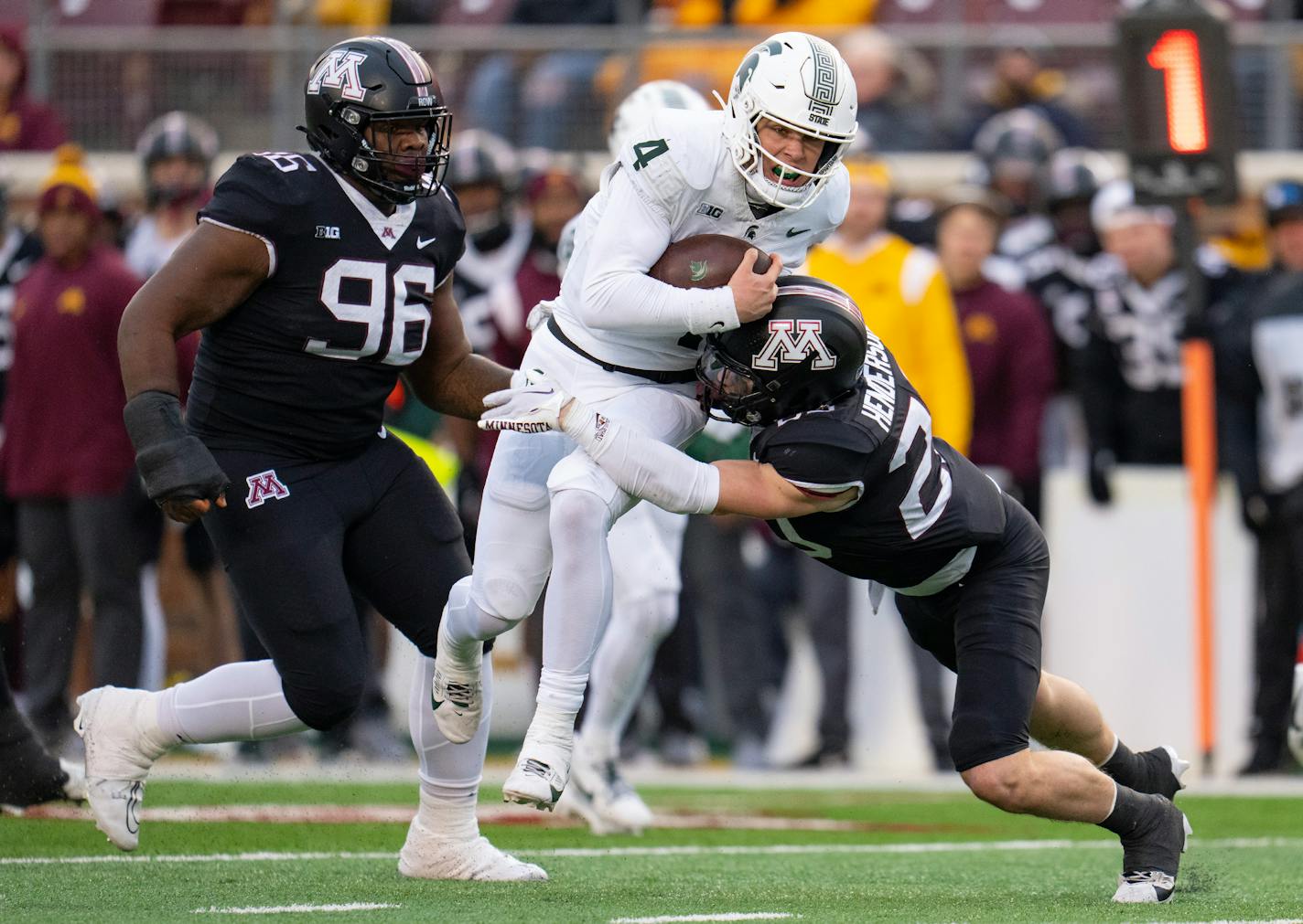 Michigan State quarterback Sam Leavitt (4) is hit by Minnesota defensive back Jack Henderson (20) in the fourth quarter Saturday, Oct. 28, 2023, at Huntington Bank Stadium in Minneapolis, Minn. ]