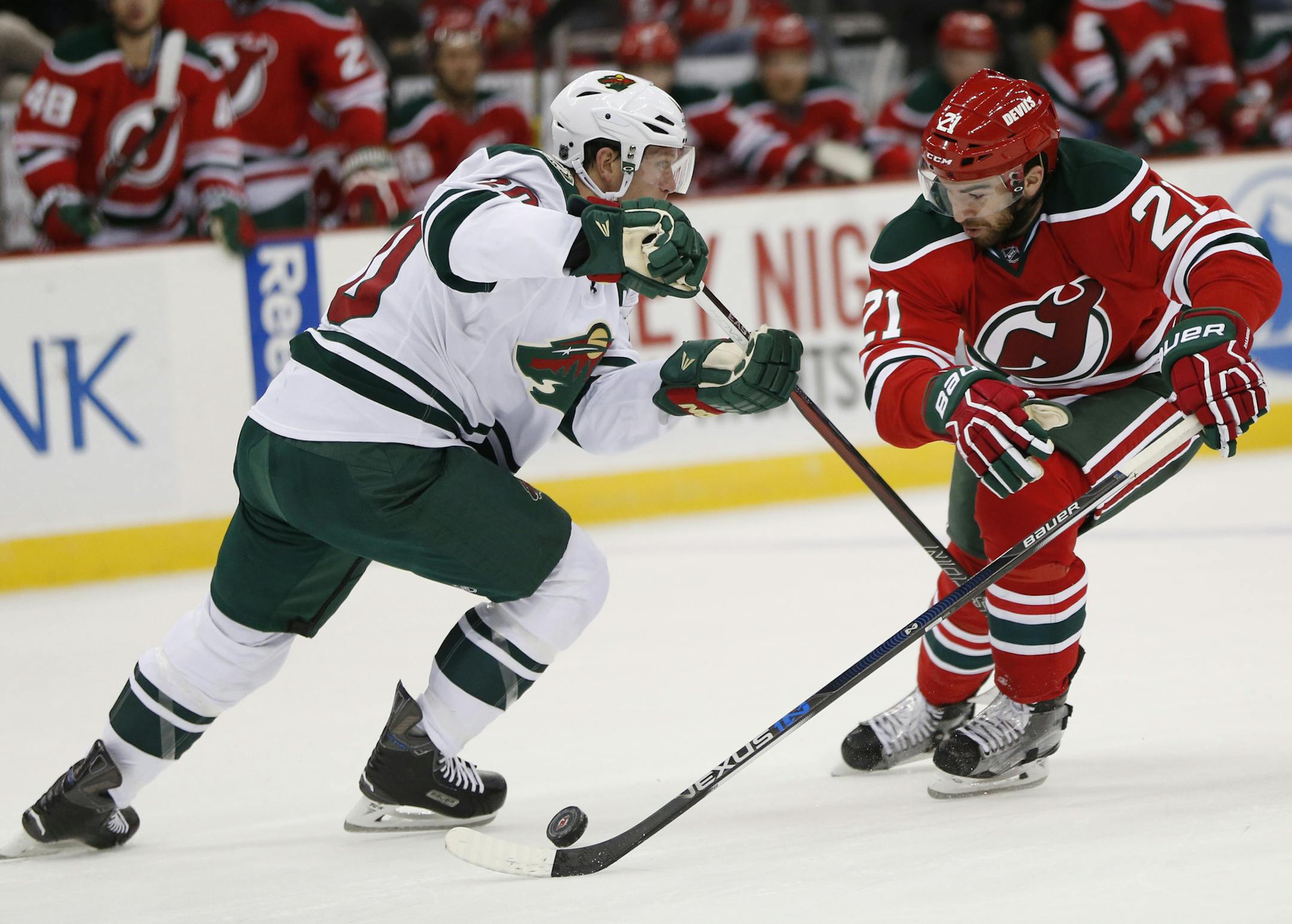 New Jersey Devils right wing Kyle Palmieri, right, skates agains Minnesota Wild defenseman Ryan Suter during the second period of an NHL hockey game, Thursday, March 17, 2016, in Newark, N.J. (AP Photo/Julio Cortez)
