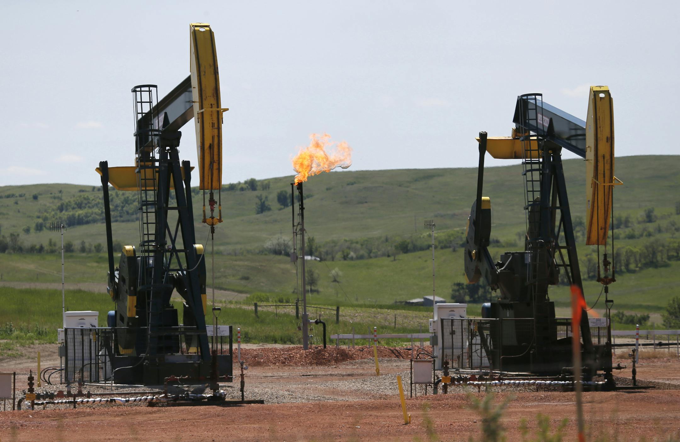 The latest oil production figures from North Dakota show an uptick in output and drilling. (AP file photo/Charles Rex Arbogast)