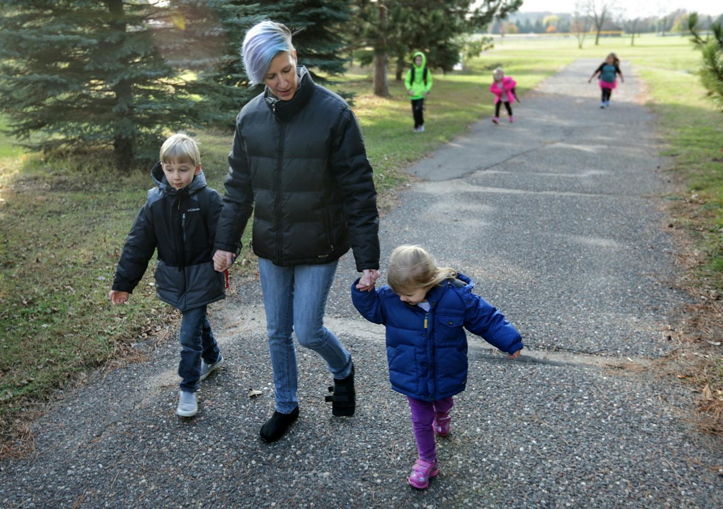 Malina Hruby with her 2-year-old daughter walks her 5-year-old son home from school just a couple blocks away rom their home in Dayton. Hruby lives a few miles away from where the state plans to move three convicted rapists, currently in the Minnesota Sex Offender Program and is very concerned for her children's safety. ] brian.peterson@startribune.com
Dayton, MN 10/27/16