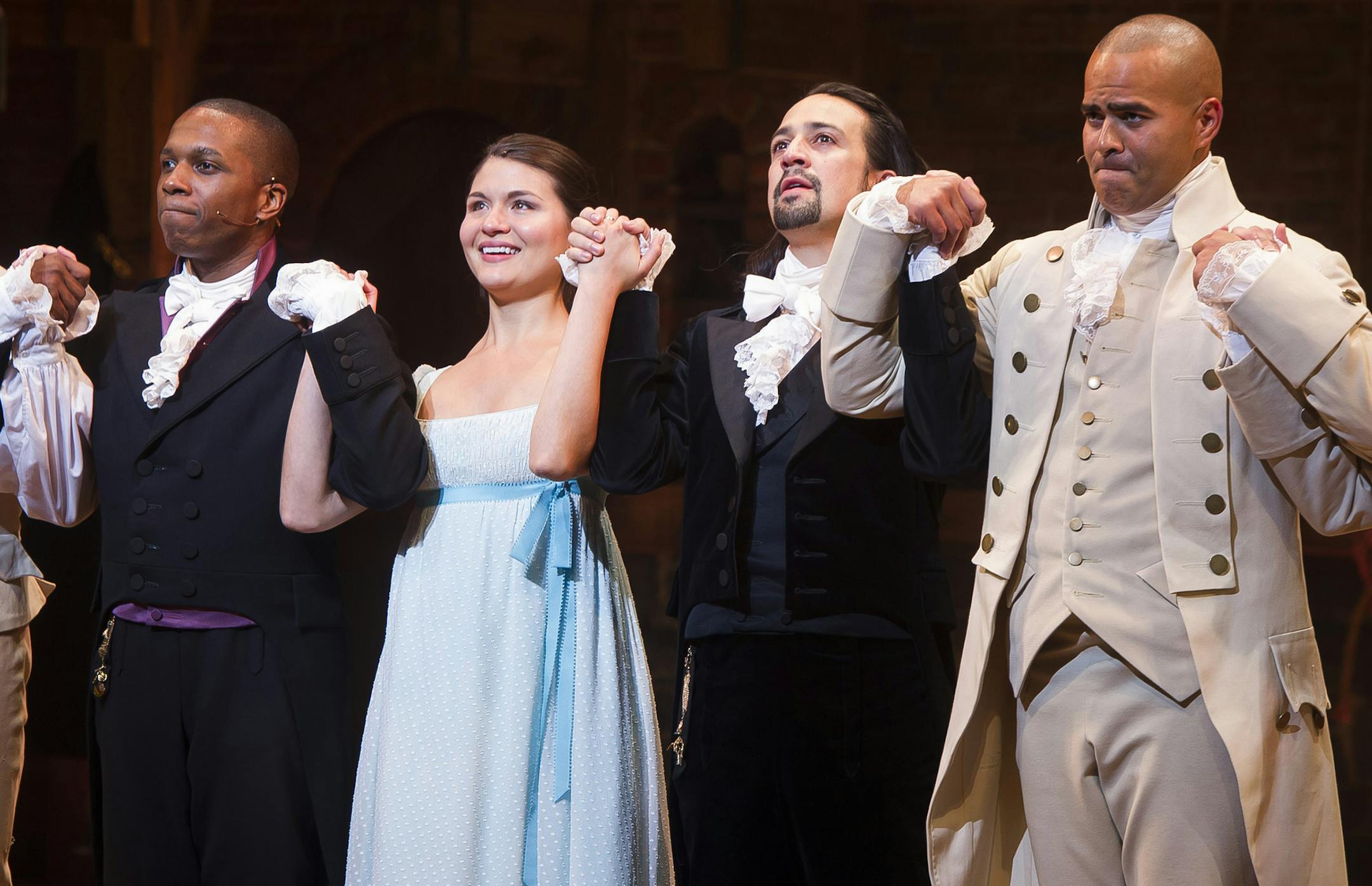 In this Thursday, Aug. 6, 2015, file photo, Leslie Odom Jr., from left, Phillipa Soo, Lin-Manuel Miranda and Christopher Jackson appear at the curtain call following the opening night performance of "Hamilton" at the Richard Rodgers Theatre in New York. Fans of Broadway gave producers reasons to smile this Christmas, with 18 of the current 37 shows breaking the $1 million mark for the week, led by ìHamilton,î the new Andrew Lloyd Webber musical ìSchool of Rock _ The Musicalî