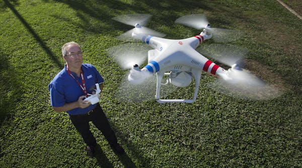 Timothy Pantle operates a remote-controlled helicopter equipped with a high-definition video camera at a park in Fair Oaks, Calif., on Thursday, Nov. 