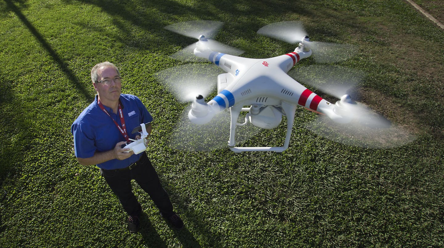 Timothy Pantle operates a remote-controlled helicopter equipped with a high-definition video camera at a park in Fair Oaks, Calif., on Thursday, Nov. 6, 2014. (Randall Benton/Sacramento Bee/TNS)