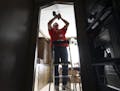Red Cross volunteer Warren Buerkley, who goes door-to-door, installed a smoke detector in a home in Inver Grove Heights.