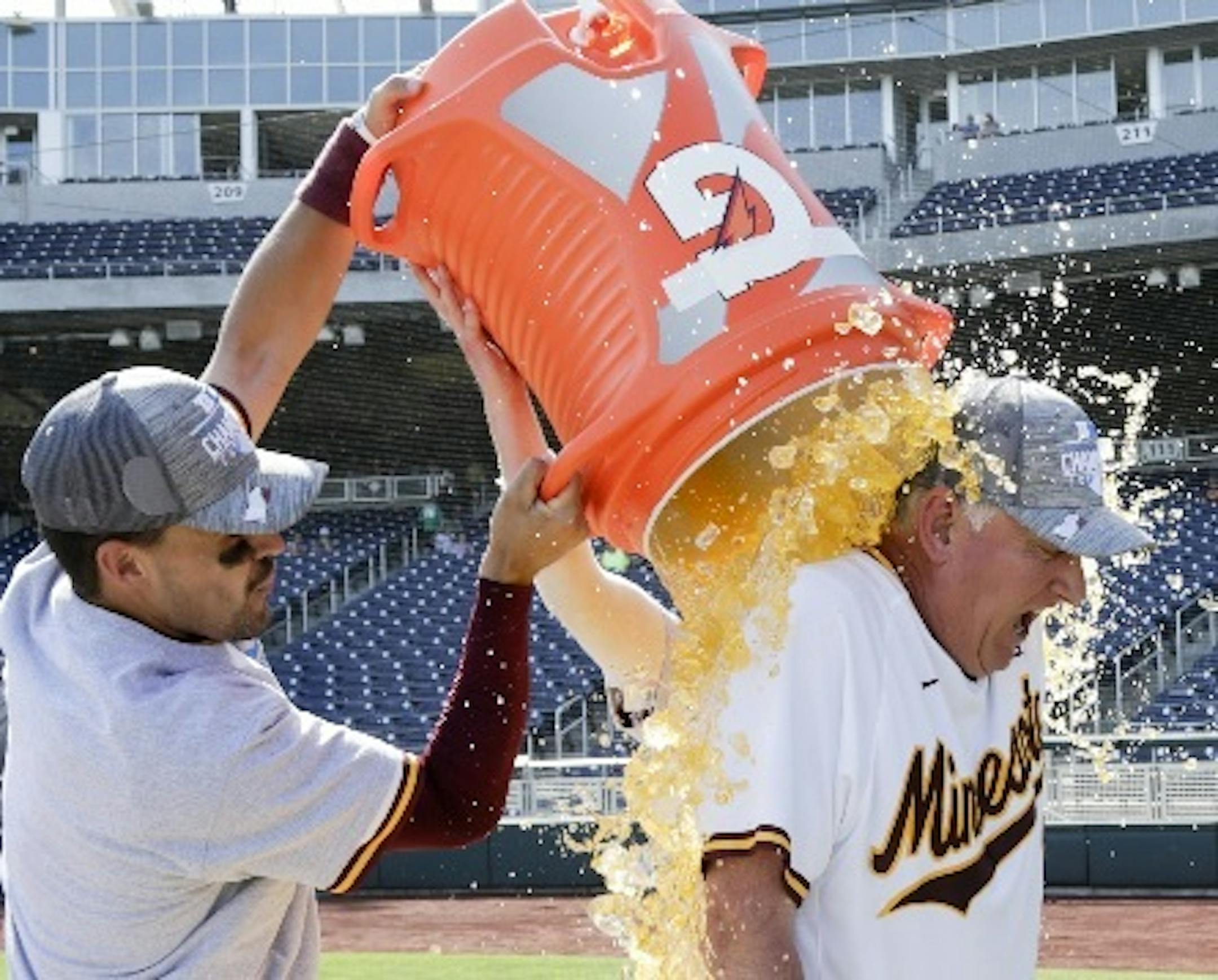 Gophers third baseman Micah Coffey, left, and second baseman Luke Pettersen drenched coach John Anderson following Minnesota's 6-4 victory over Purdue for the Big Ten baseball tournament championship in Omaha, Neb., on Sunday.
