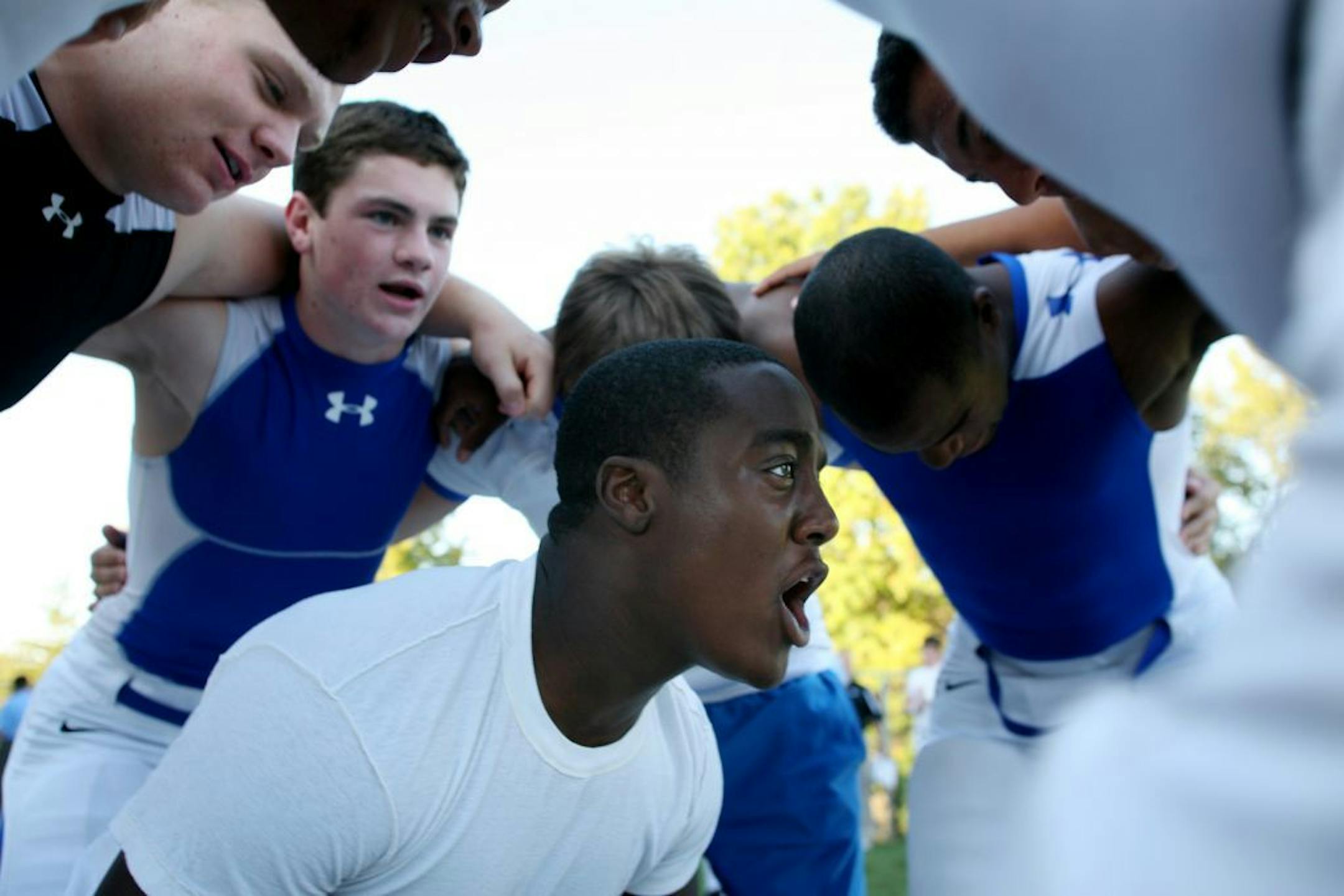 Minnetonka's Sam Alakija, center, gave his teammates a pre-game pep talk prior to the team's game against Rockhurst.