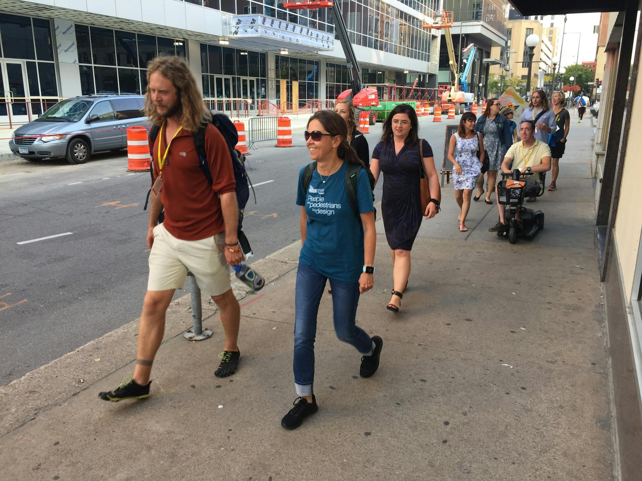 Jonathan Stalls and Gosia Kung lead a group through downtown St. Paul on their way to dinner, after a day discussing walking issues at the National Walk Summit.