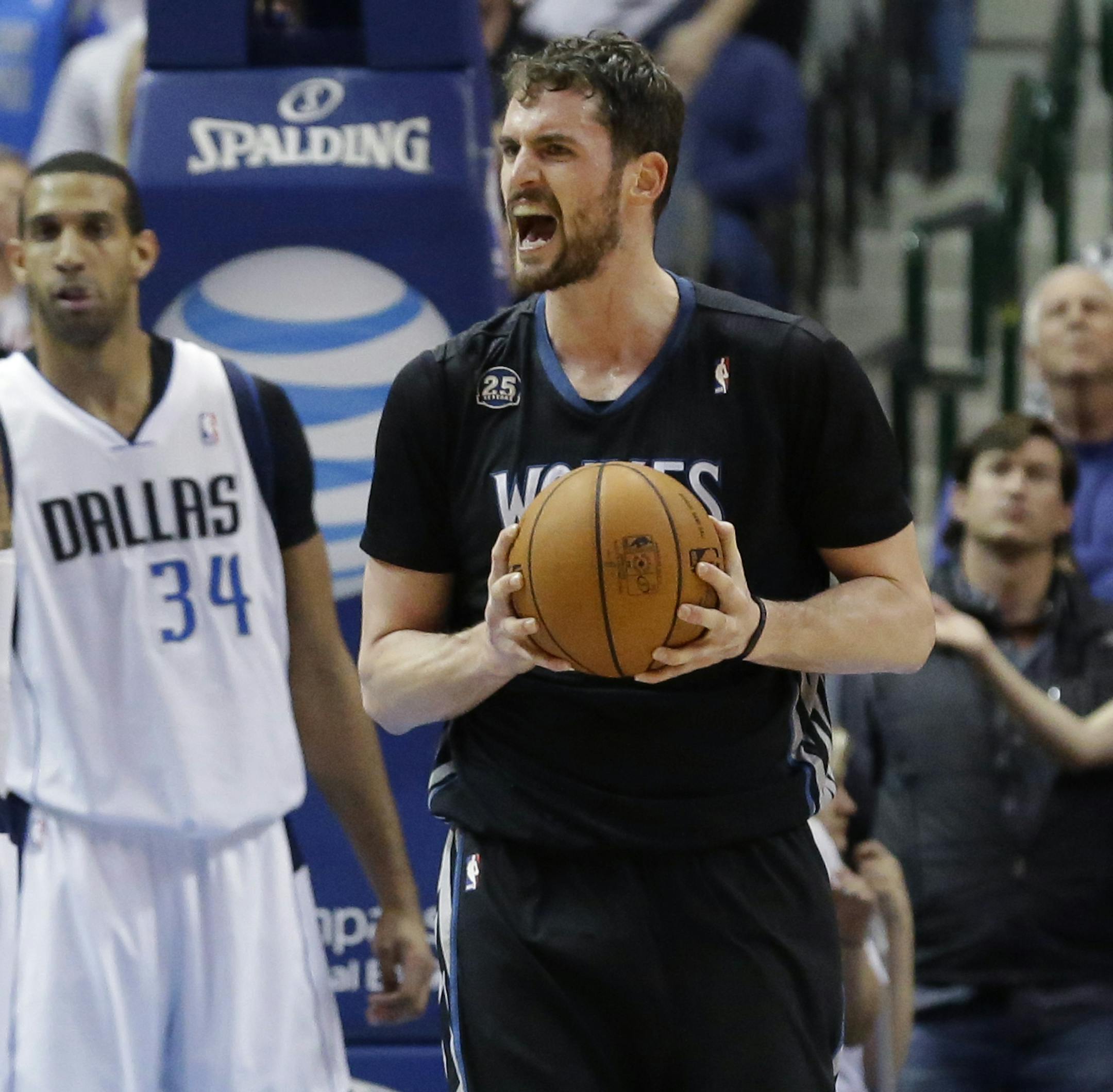 Minnesota Timberwolves forward Kevin Love (42) lets out a yell after a play against Dallas Mavericks Brandan Wright (34) during overtime play during an NBA basketball game Wednesday, March 19, 2014, in Dallas. The Timberwolves won in overtime 123-122. (AP Photo/LM Otero)